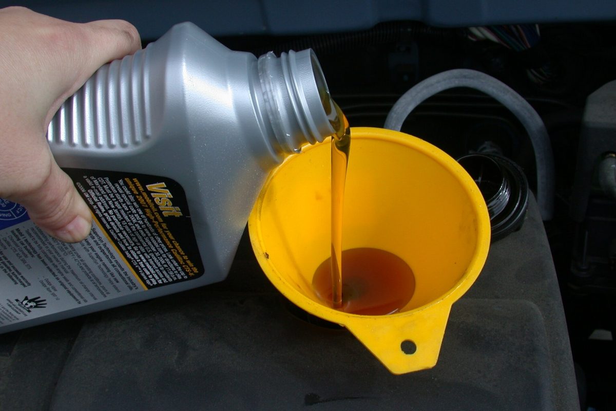 Adding engine oil through a funnel
