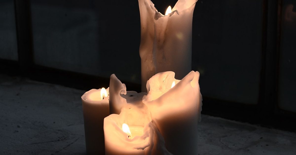 Candles lit in a dark home during a long power outage