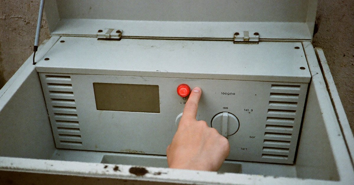 Pointing at a warning light on a generator control panel