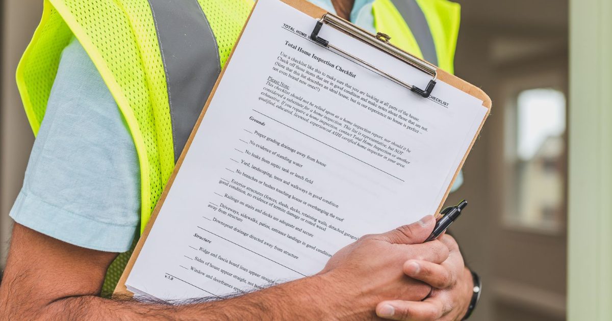 Home inspector holding a checklist on a clipboard