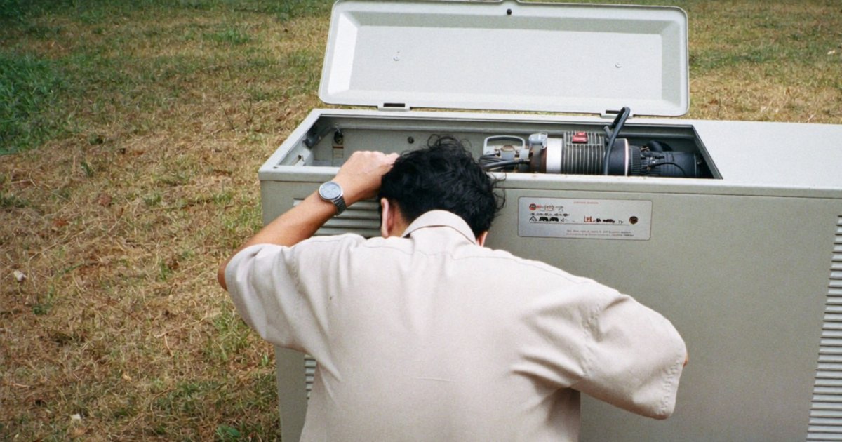 Technician inspecting the engine of a standby generator