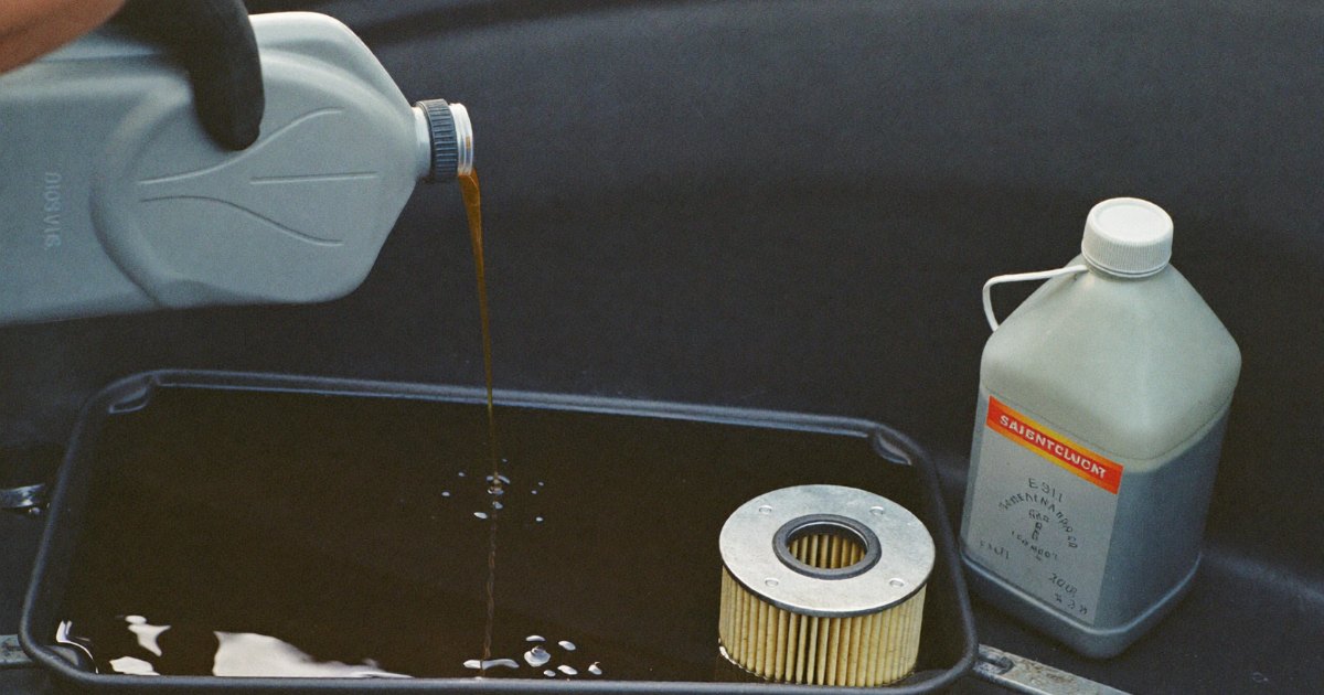 Draining old oil from a small generator engine into a drain pan