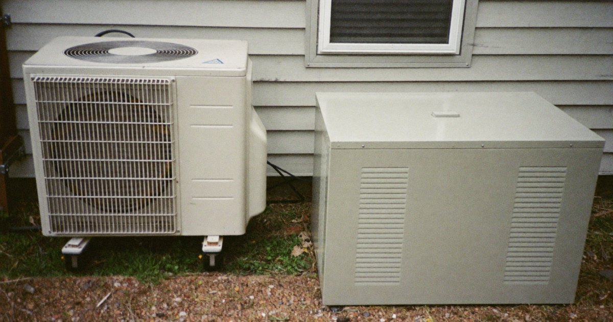 Central air conditioner condenser next to a standby generator