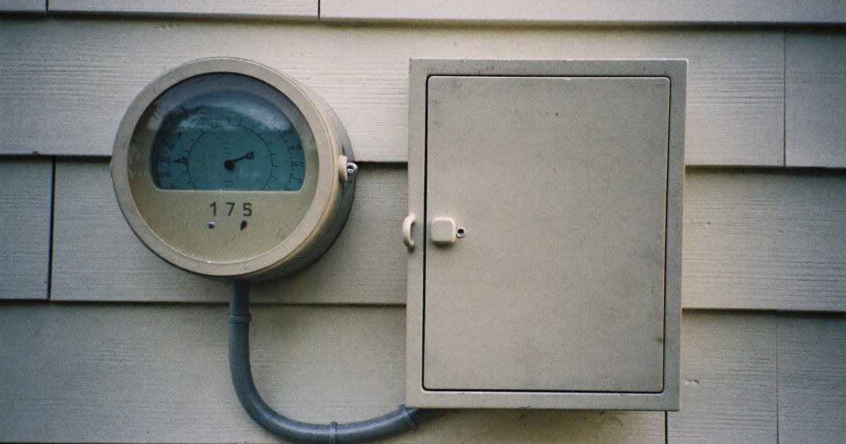 Electric meter next to an outdoor transfer switch enclosure