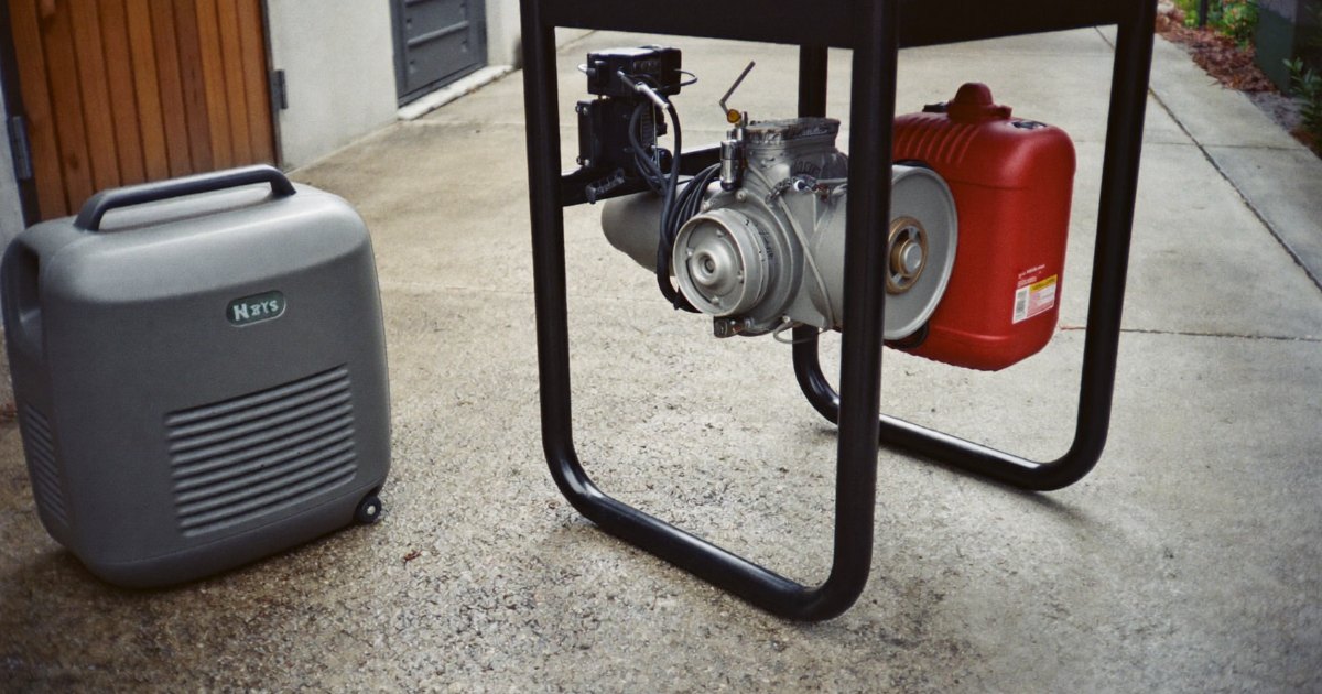 Compact inverter generator next to a conventional open-frame portable generator
