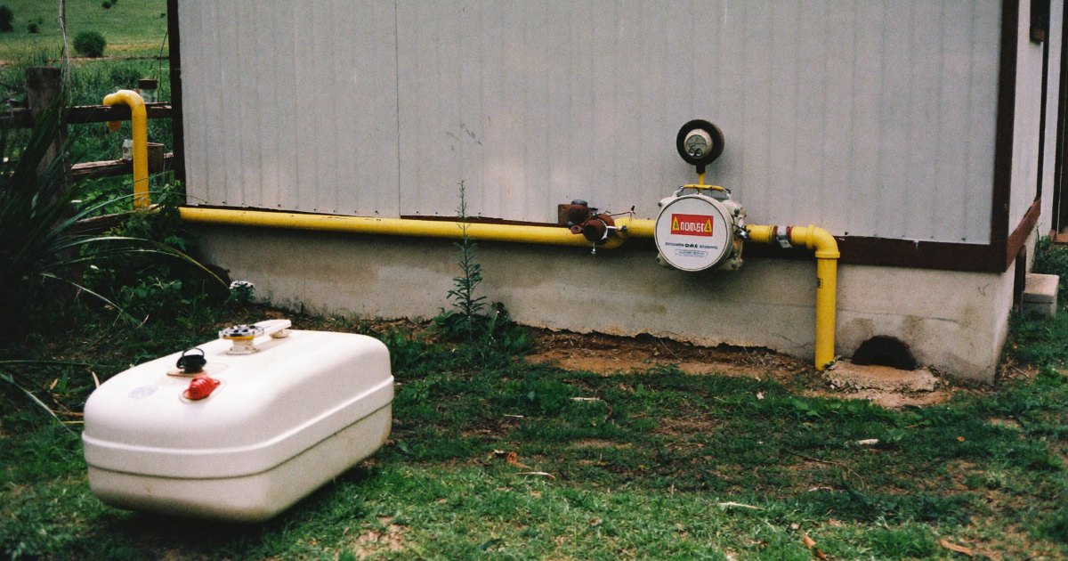 Propane tank and natural gas meter at a rural home