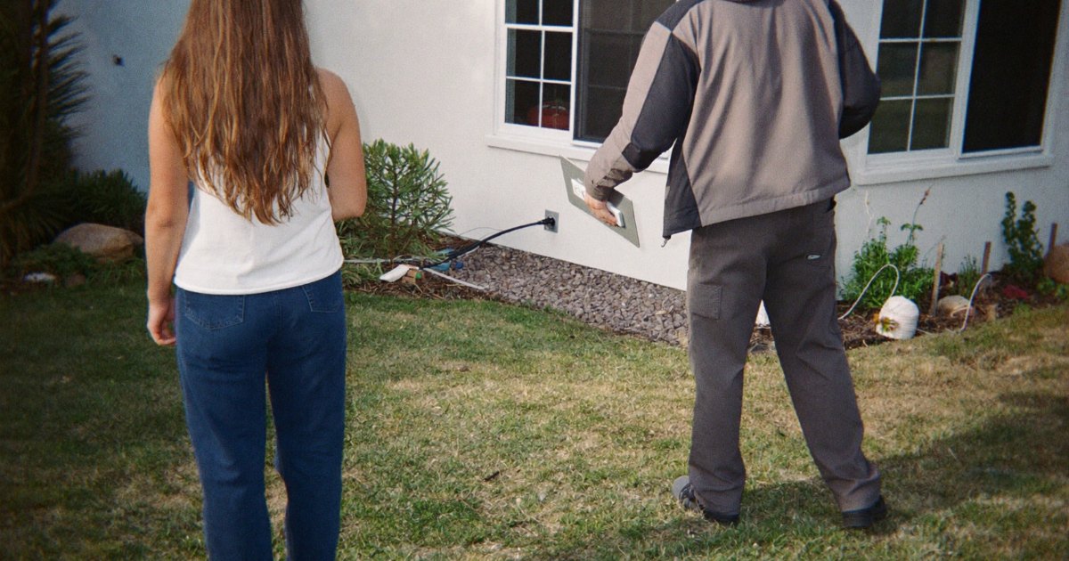 Installer showing a homeowner where a generator could be installed