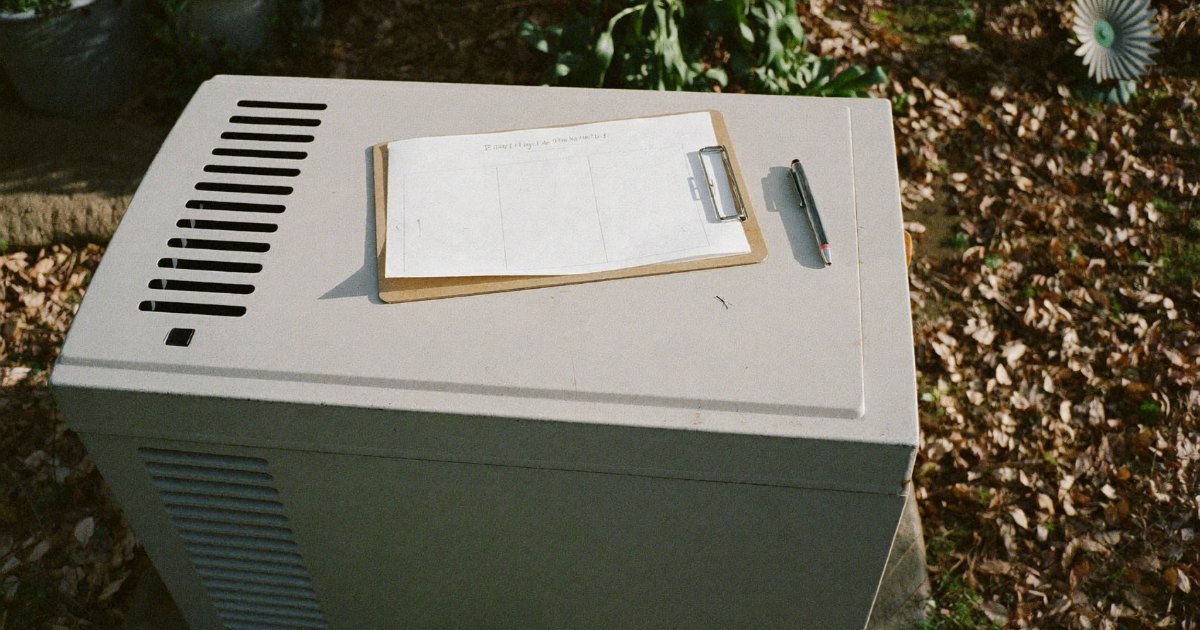 Maintenance checklist on a clipboard resting on a standby generator