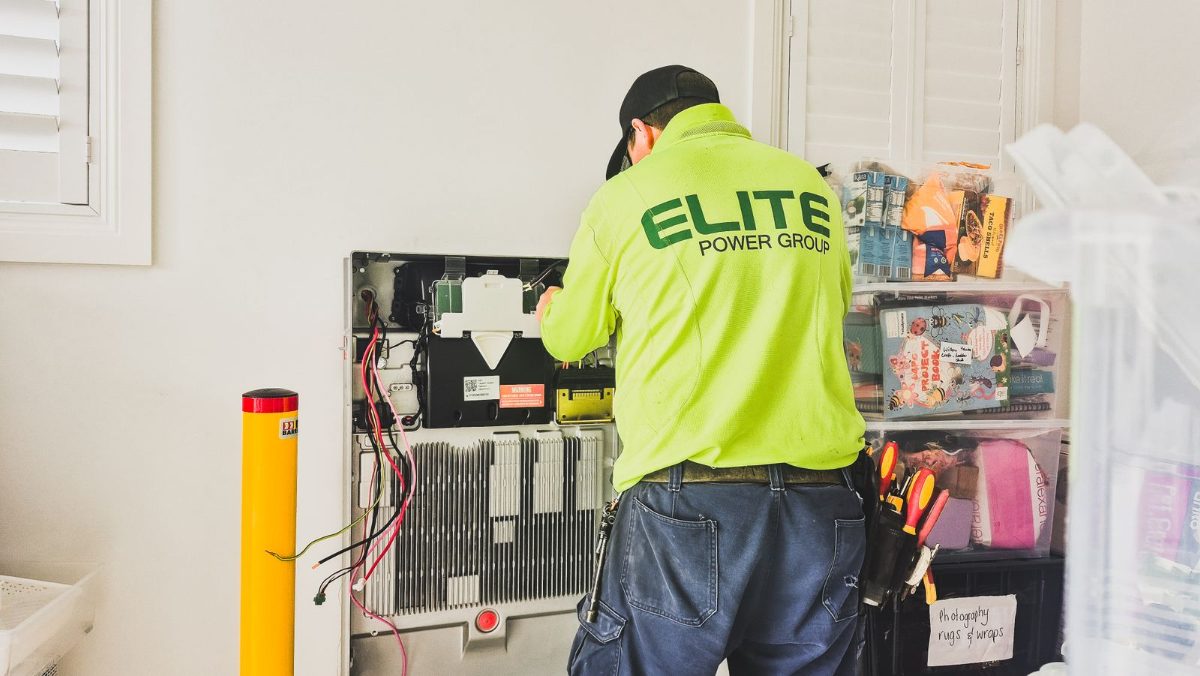 Technician installing a home battery backup system